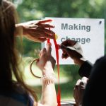 Hands writing making change