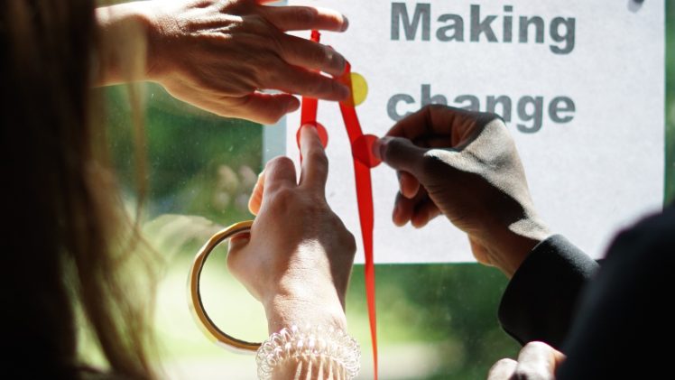 Hands writing making change