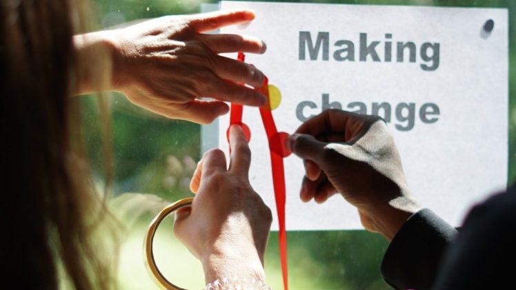 Hands writing making change